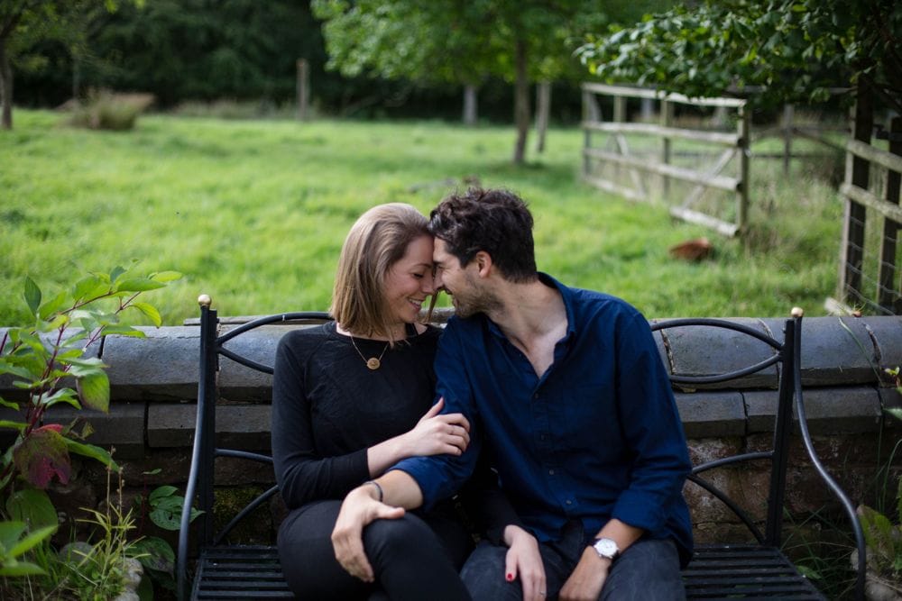 Couple photo shoot on bench outdoors summer time countryside