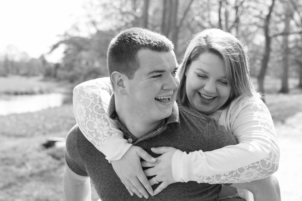 Attingham park couple shoot black and white photo piggy back laughing