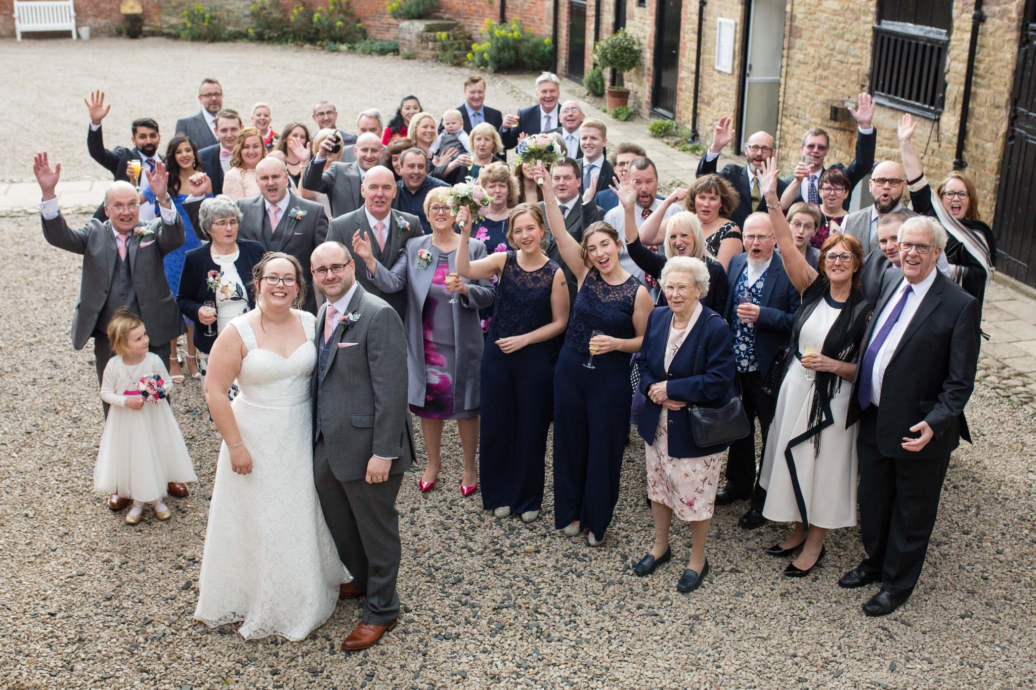 Large group photo exterior Delbury Hall Spring wedding