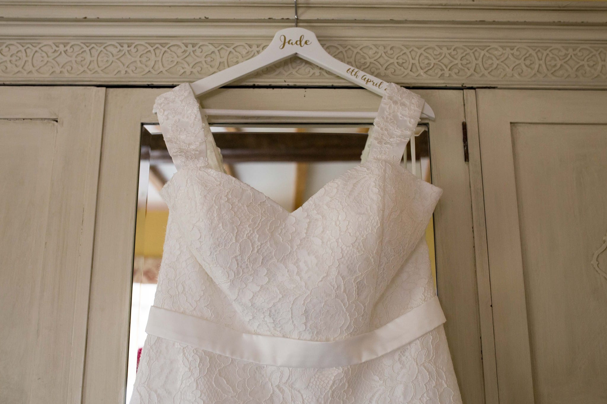 Delbury Hall wedding dress hanging on wardrobe door