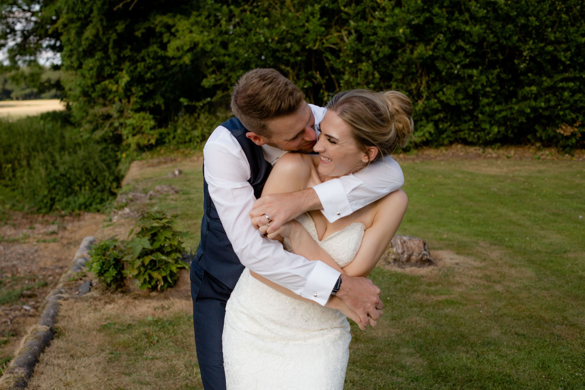 Shropshire wedding photographer golden hour romantic portraits of a couple laughing at Somerford Hall