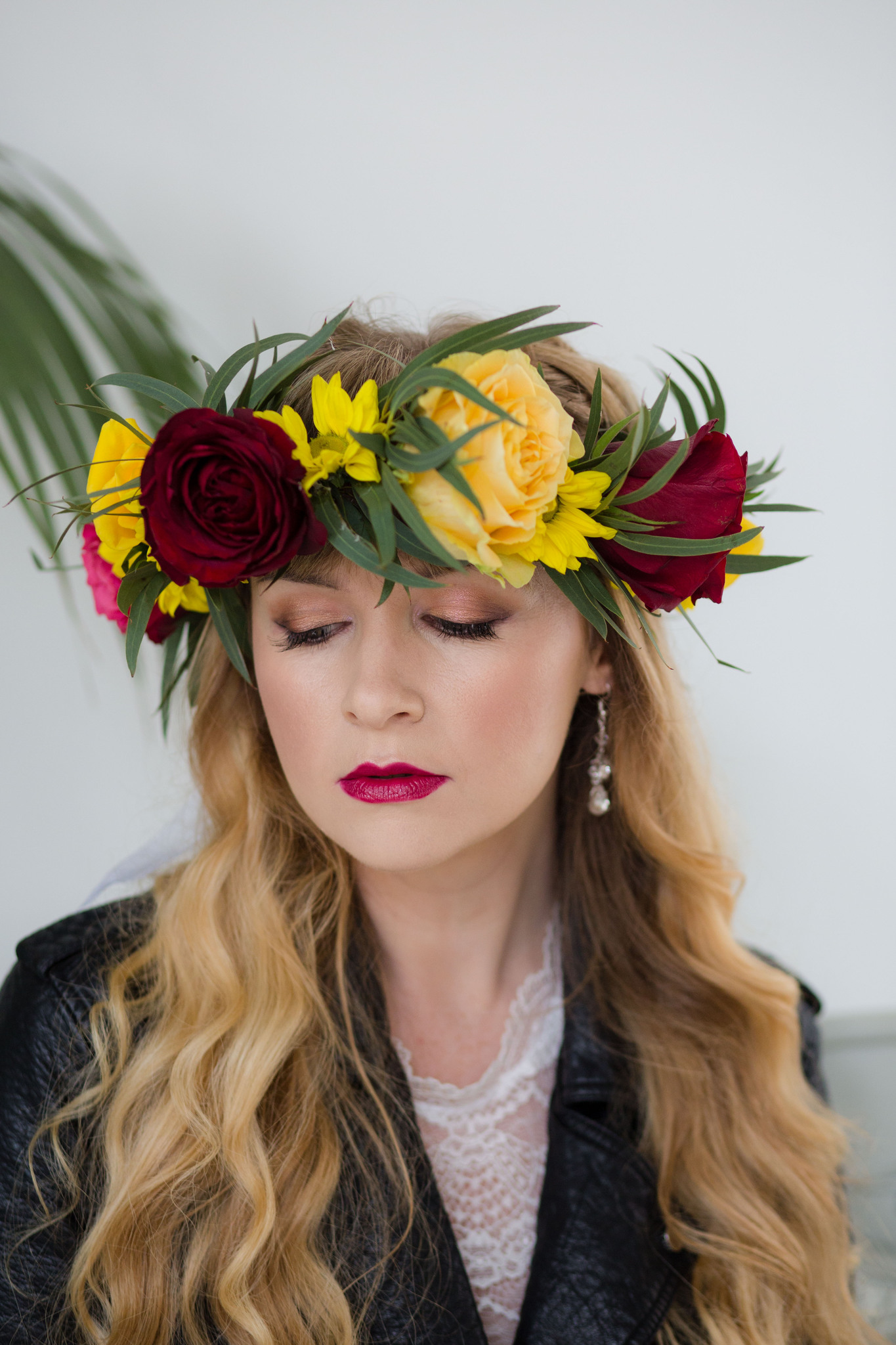 Boho Bride wearing flower crown and leather jacket and bridal jumpsuit