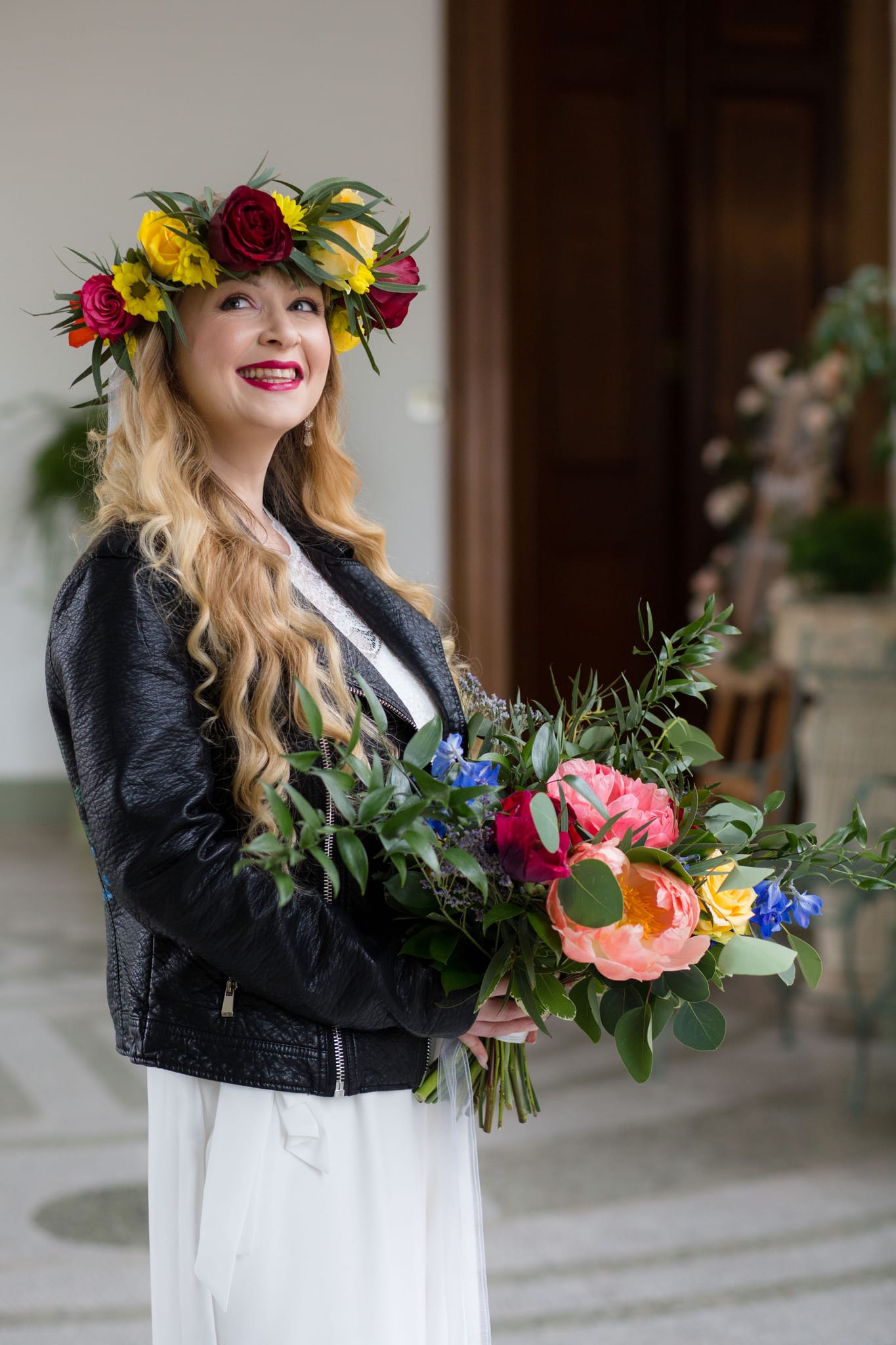 Boho Bride wearing flower crown and leather jacket and bridal jumpsuit