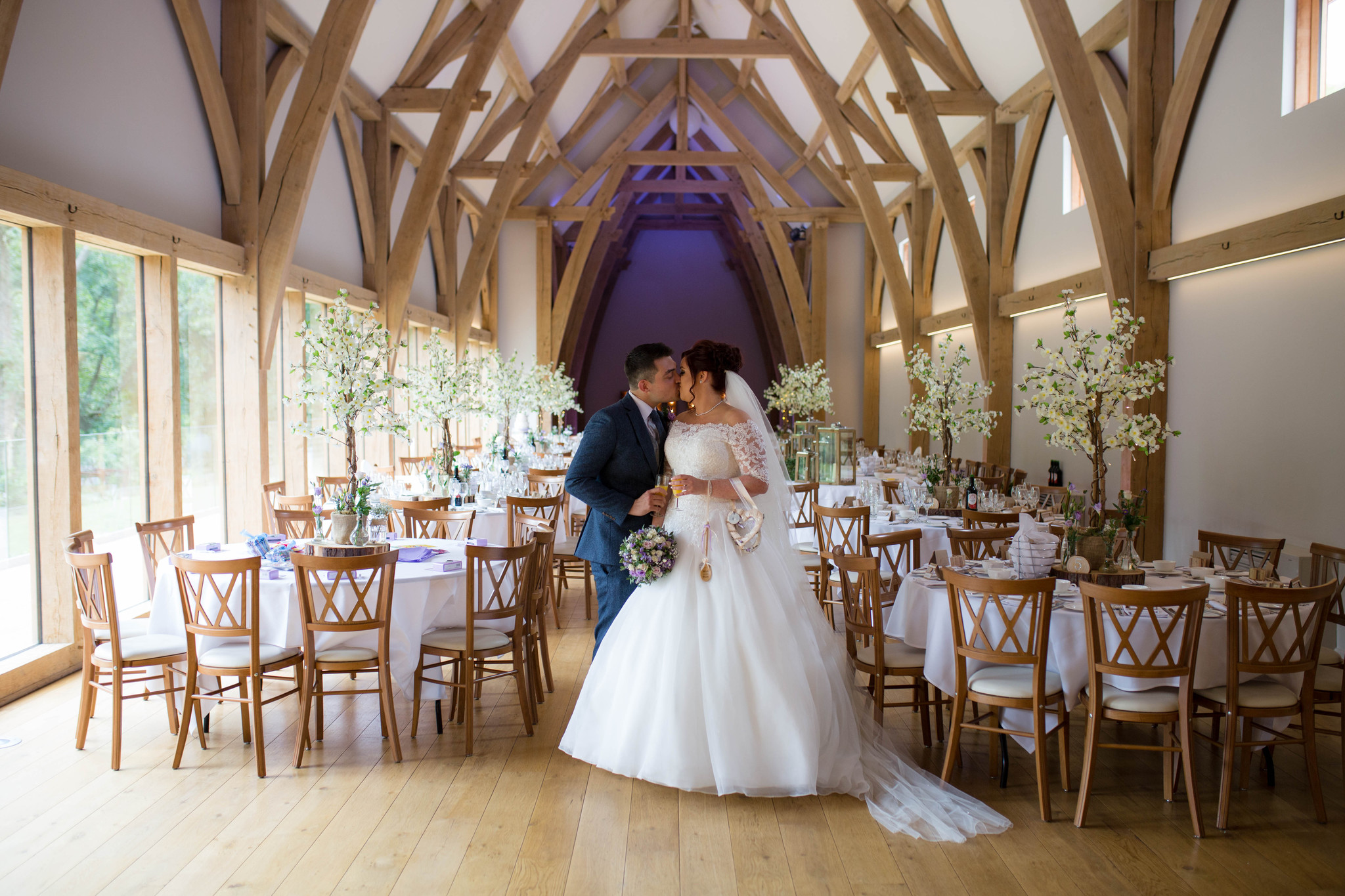 mill barns wedding venue wedding breakfast set up with blossom trees 