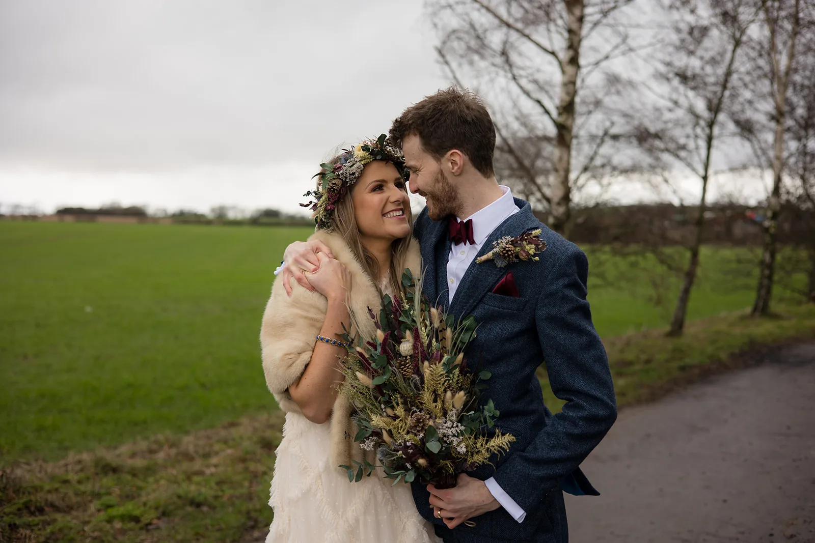 Shropshire wedding photographer A couple on their wedding day hugging close looking happy