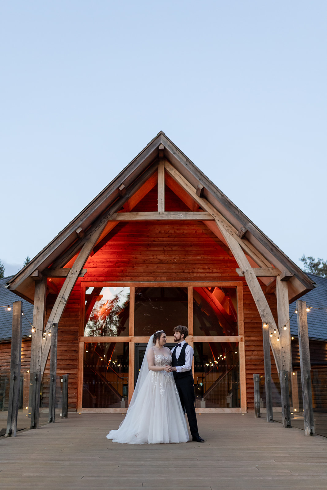 Mill Barns wedding venue at dusk with couple out the front