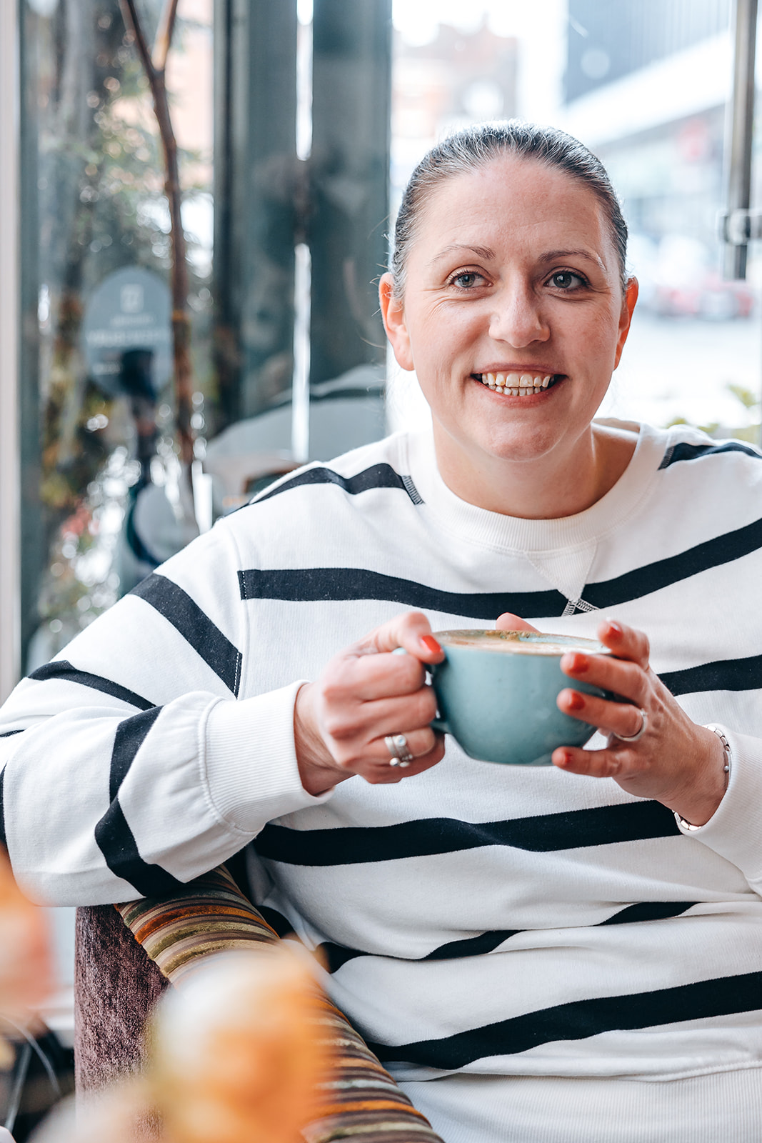 Woman drinking coffee in a coffee shop