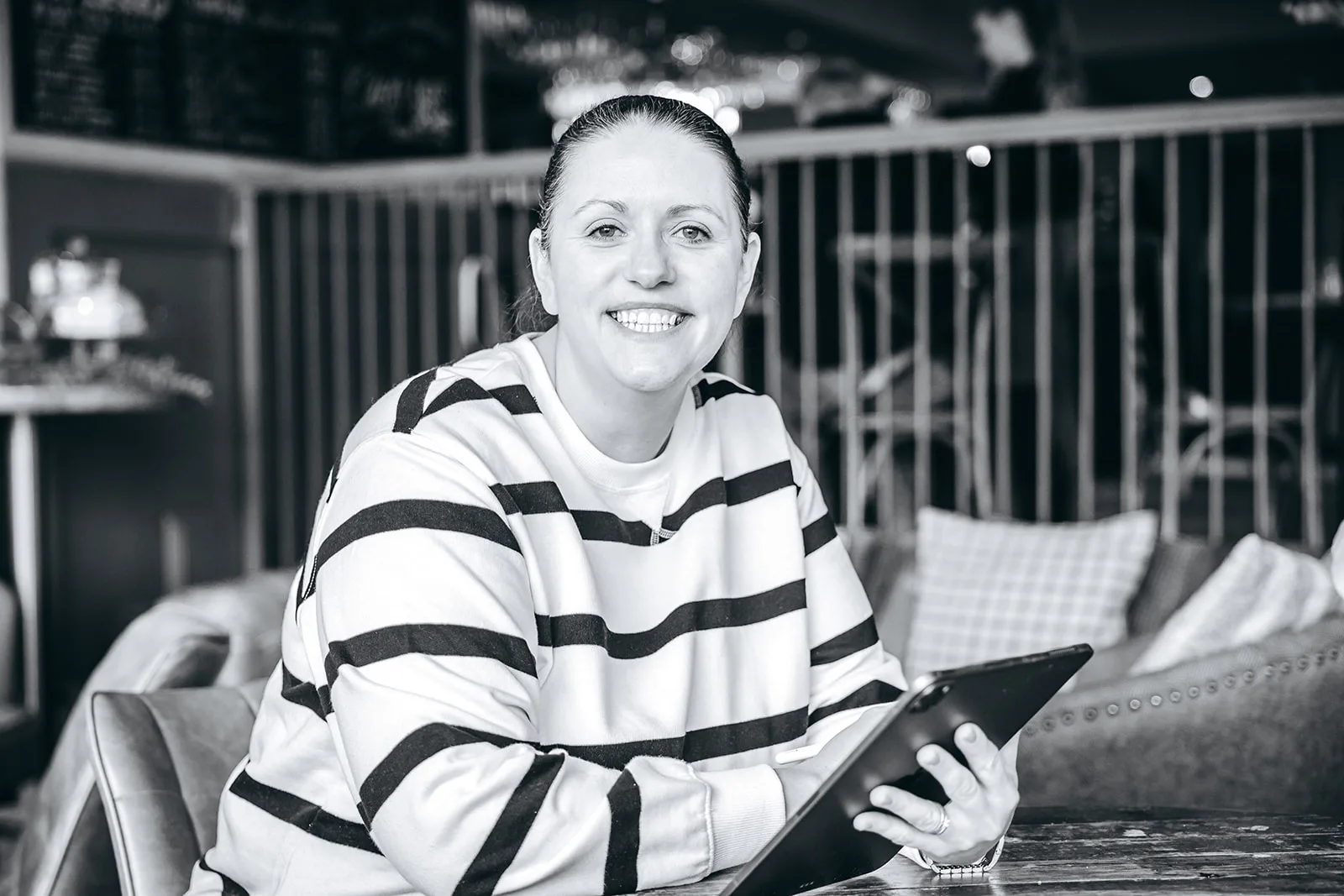 Shropshire wedding photographer Nicola Gough Photography Woman smiling and using an iPad as a notebook