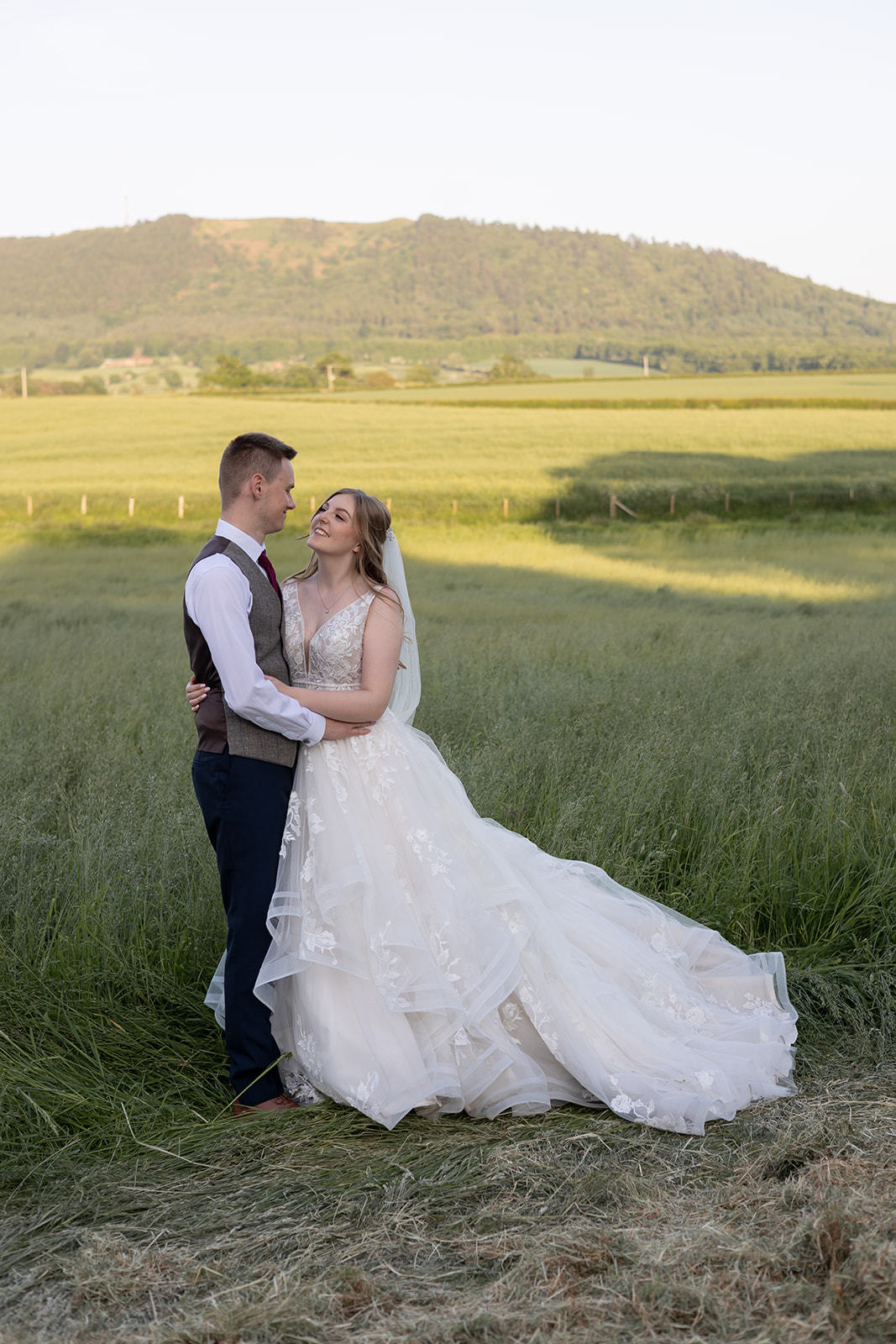 Couple on wedding day with The Wrekin hill behind them