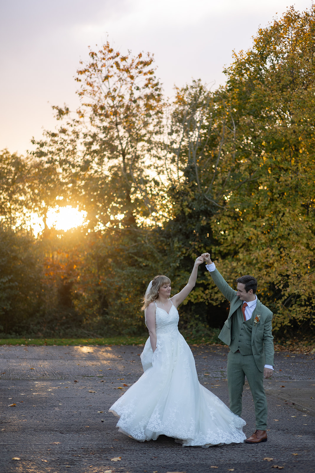 Couple on wedding day dancing at sunset
