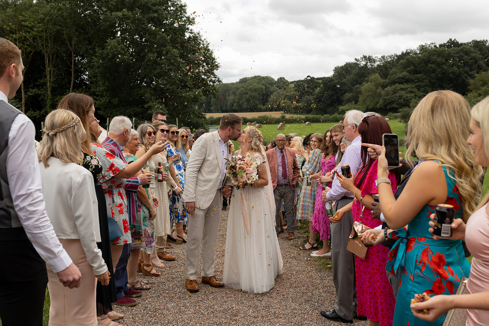 Wedding day couple walking through confetti