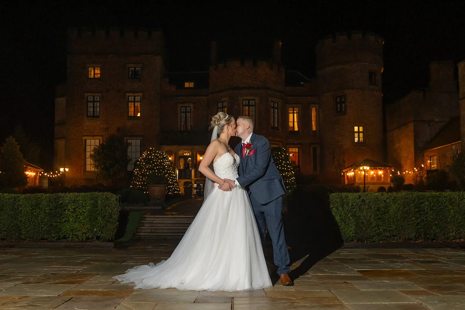 Rowton Castle Christmas wedding Nightime wedding photo of a couple in front of Rowton castle at Christmas time